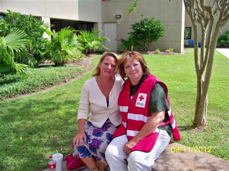 In this Sept. 11, 2012 photo provided by the American Red Cross, Brenda LaFlamme, left, waits outside Ochsner Medical Center-North Shore in Slidell, La., with Deborah Kemp, of Ann Arbor, Mich., a volunteer with the American Red Cross Safe and Well program. Kemp reunited LaFlamme with her father, Larry Bailey, who was treated at the hospital after being rescued from Hurricane Isaac's floods on Aug. 30, 2012. He had been brought to the emergency room several days after the rescue, incoherent and bleeding from an infected month-old wound.  (AP Photo/American Red Cross, Louis Palm)